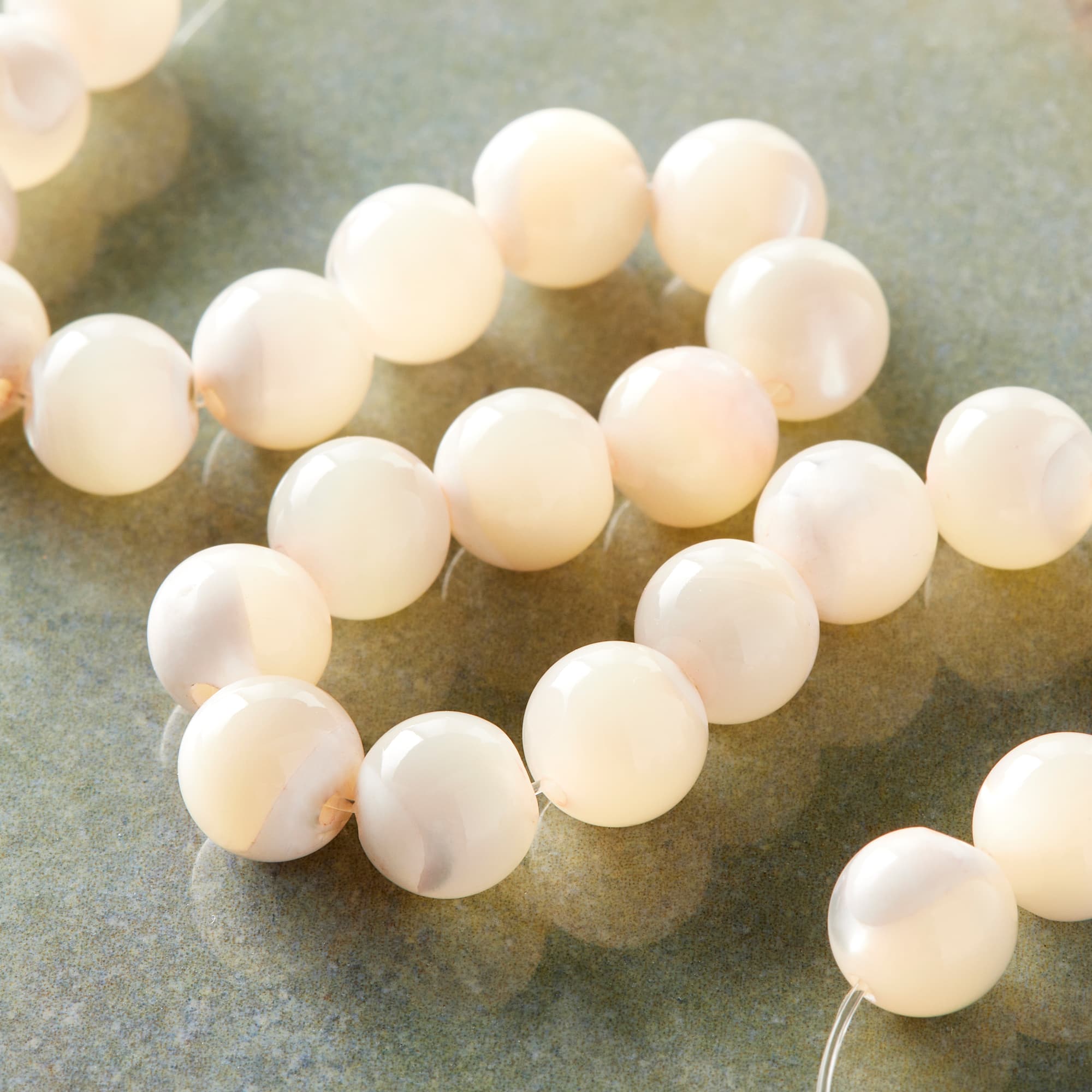 12 Pack: 7mm Light Pink Mother of Pearl Round Beads by Bead Landing™
